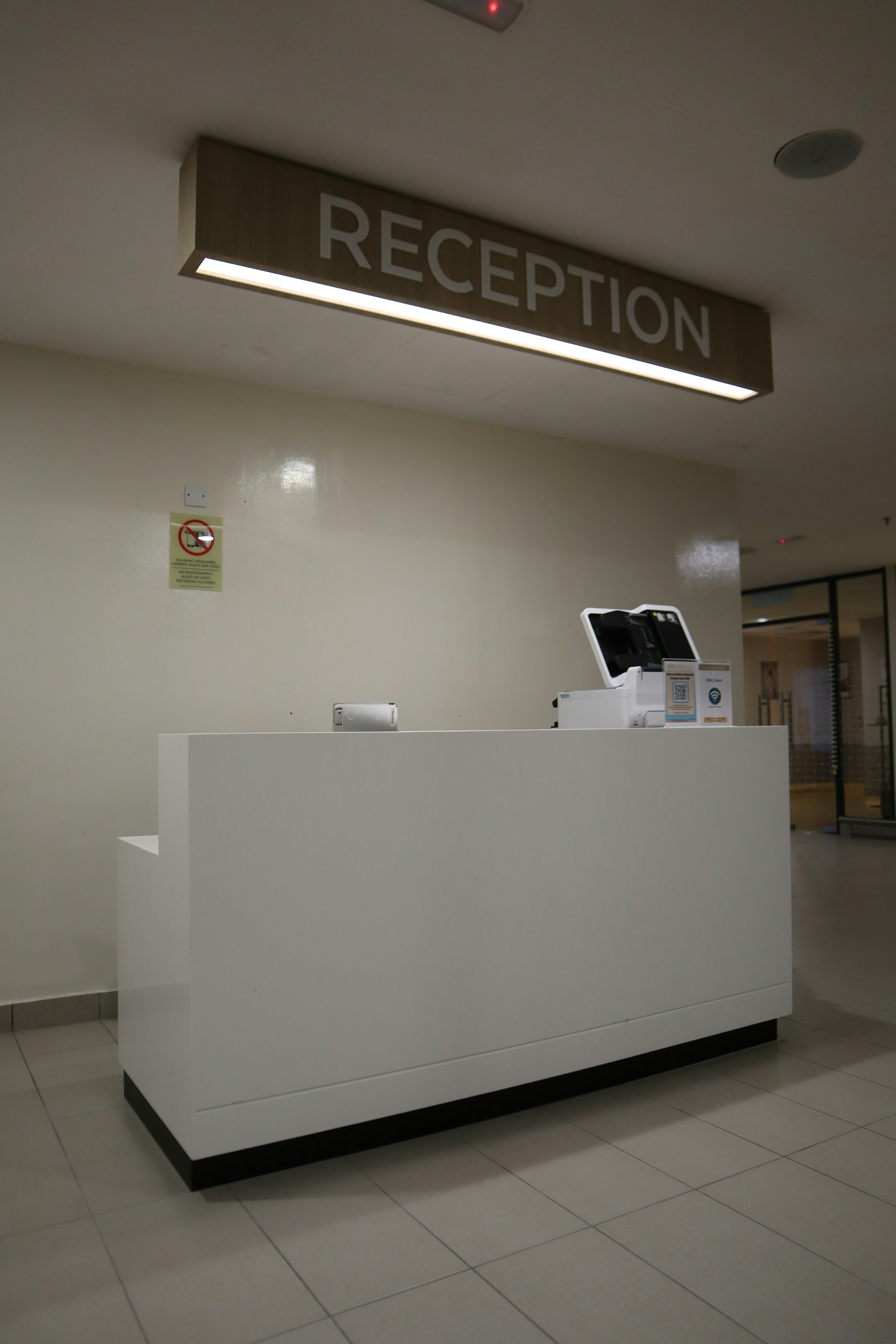 Calm, professional hospital reception environment.
